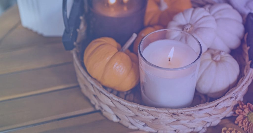 Pumpkins in a basket with candles