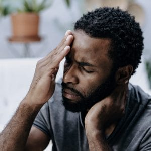 Man holding head and neck in pain