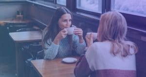 2 women having coffee together in a cafe.