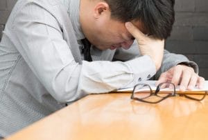 Man with headache in the workplace